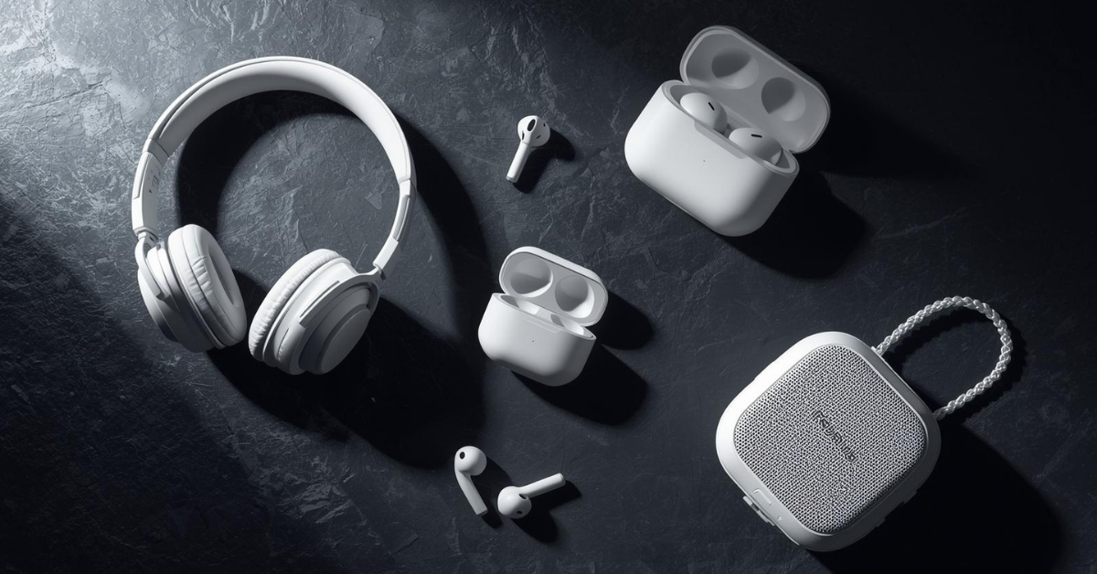 Modern Audio devices on a desk setup including wireless earbuds, a gaming headset, and a smartwatch under natural lighting.